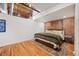 Comfortable bedroom featuring exposed brick accents, hardwood floors, and ample natural light at 1801 Wynkoop St # 518, Denver, CO 80202