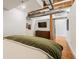 Bedroom with exposed ductwork, hardwood floors, and neutral decor at 1801 Wynkoop St # 518, Denver, CO 80202