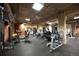 A fully-equipped gym with diverse exercise machines and exposed brick pillars for a complete fitness experience at 1801 Wynkoop St # 518, Denver, CO 80202