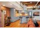 Bright, loft-style kitchen featuring grey cabinets, exposed brick accents, stainless steel appliances, and hardwood floors at 1801 Wynkoop St # 518, Denver, CO 80202