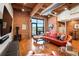 Inviting living room featuring exposed brick, hardwood floors, and large windows offering plenty of natural light at 1801 Wynkoop St # 518, Denver, CO 80202