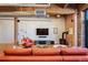 Spacious living room featuring exposed brick, a modern fireplace, and comfortable seating arrangements at 1801 Wynkoop St # 518, Denver, CO 80202