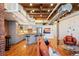 Open loft living space features hardwood floors, a modern kitchen, leather seating, and exposed beam ceiling at 1801 Wynkoop St # 518, Denver, CO 80202