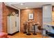 Loft living space featuring exposed brick wall detail, hardwood floors, bar table and storage at 1801 Wynkoop St # 518, Denver, CO 80202