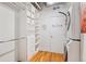 A well-organized walk-in closet with custom shelving and storage solutions, next to stacked washer and dryer at 1801 Wynkoop St # 518, Denver, CO 80202