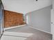 Bright bedroom featuring carpet, brick wall, and large windows at 850 20Th St # 503, Boulder, CO 80302