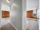 Hallway and living spaces with exposed brick walls and plush carpets at 850 20Th St # 503, Boulder, CO 80302