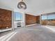 Spacious living room with exposed brick wall, neutral carpet, and floor-to-ceiling sliding glass doors at 850 20Th St # 503, Boulder, CO 80302