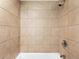 Shower stall fully tiled in earth-tone square tiles at 850 20Th St # 503, Boulder, CO 80302