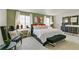 Bright bedroom boasts an accent wall, plush carpet, and neutral color scheme at 18813 E 99Th Ave, Commerce City, CO 80022