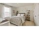 Charming bedroom with large window, floral wall decor, and neutral color palette at 18813 E 99Th Ave, Commerce City, CO 80022