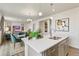 Kitchen with a large island and gray cabinets open to the dining and living area at 18813 E 99Th Ave, Commerce City, CO 80022