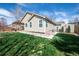 Landscaped backyard with a covered patio featuring a pergola and a lush green lawn at 271 Terra Vista St, Brighton, CO 80601