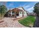 Backyard view of a covered patio with a pergola and lush green lawn at 271 Terra Vista St, Brighton, CO 80601