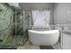 Modern bathroom featuring a luxurious soaking tub, glass-enclosed shower, and elegant fixtures for a serene bathing experience at 271 Terra Vista St, Brighton, CO 80601