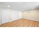 Spacious bedroom with laminated flooring, white trim, and three closets at 271 Terra Vista St, Brighton, CO 80601