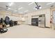 Spacious garage featuring bright lighting, white walls, and built-in storage cabinets at 271 Terra Vista St, Brighton, CO 80601