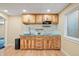Charming kitchenette with custom wood cabinets, stainless steel sink, and modern backsplash at 271 Terra Vista St, Brighton, CO 80601