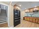 Basement kitchenette with natural wood cabinets, stainless steel appliances, and stylish countertops at 271 Terra Vista St, Brighton, CO 80601