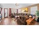 Cozy living room with a large, comfortable sectional and hardwood floors at 271 Terra Vista St, Brighton, CO 80601