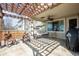 Covered patio with stamped concrete, ceiling fan, pergola, and bench seating at 271 Terra Vista St, Brighton, CO 80601
