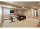 Finished basement with a comfortable couch, exercise equipment, and natural light from the window at 520 Jackson St, Denver, CO 80206