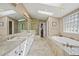 Luxurious bathroom with dual sinks, soaking tub, and walk-in shower with neutral tile at 520 Jackson St, Denver, CO 80206