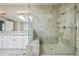 Elegant bathroom featuring a glass-enclosed shower, dual vanity, and marble-look finishes at 520 Jackson St, Denver, CO 80206