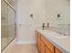 Bright bathroom featuring a shower-tub combo, a spacious vanity and neutral-toned tile flooring at 520 Jackson St, Denver, CO 80206
