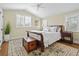 Charming bedroom featuring a sleigh bed with white linens, an area rug, and ample natural light at 520 Jackson St, Denver, CO 80206