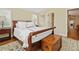 Comfortable bedroom with hardwood floors, a wooden chest and access to an en-suite bathroom at 520 Jackson St, Denver, CO 80206