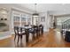 Elegant dining room with hardwood floors, large windows, and a stylish chandelier fixture at 520 Jackson St, Denver, CO 80206
