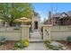 Charming home featuring a gated courtyard with lush landscaping and inviting outdoor living space at 520 Jackson St, Denver, CO 80206