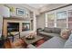 Inviting living room features a fireplace, plush seating, and natural light from the window at 520 Jackson St, Denver, CO 80206