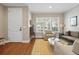 Bright living room featuring hardwood floors, plantation shutters, and comfortable seating arrangement at 520 Jackson St, Denver, CO 80206