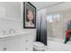 Bathroom with a bathtub, shower, and white vanity at 5511 Leyden St, Commerce City, CO 80022