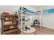 Bedroom with loft bed, desk, and built in shelving at 5511 Leyden St, Commerce City, CO 80022