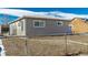 Exterior view of the house, light grey siding at 5511 Leyden St, Commerce City, CO 80022