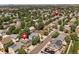 A vibrant aerial view of a residential area, showcasing homes with lush trees and community pool at 1359 S Beeler Ct, Denver, CO 80247