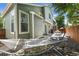 Inviting backyard featuring a hammock, patio set, and green exterior of the home at 1359 S Beeler Ct, Denver, CO 80247