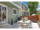 Cozy backyard patio with modern outdoor dining set and lush green surroundings at 1359 S Beeler Ct, Denver, CO 80247