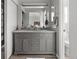 Elegant bathroom with a double sink vanity, a large mirror, and a separate toilet area for added privacy at 1359 S Beeler Ct, Denver, CO 80247