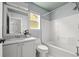 Bright bathroom with tiled shower, white vanity and modern fixtures offers a clean aesthetic at 1359 S Beeler Ct, Denver, CO 80247