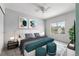 Bedroom showcasing a well-lit space with modern decor, stylish art, plush bed, and a bright window view at 1359 S Beeler Ct, Denver, CO 80247