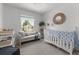 Cozy Bedroom with a crib, daybed, soft lighting, and storage, creating a calming and inviting space at 1359 S Beeler Ct, Denver, CO 80247