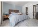 Bedroom with a blue accent wall, wooden headboard, closet, side tables, and a patterned rug at 1359 S Beeler Ct, Denver, CO 80247