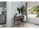 Bedroom featuring a vanity table and a window view, complemented by a modern sink and mirror in the bathroom at 1359 S Beeler Ct, Denver, CO 80247