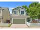 Charming two-story home with green siding, well-maintained lawn, and attached two-car garage at 1359 S Beeler Ct, Denver, CO 80247