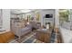 Cozy living room with hardwood floors, comfortable armchairs, and access to the dining area at 1359 S Beeler Ct, Denver, CO 80247