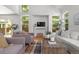 Spacious living room with abundant natural light, comfortable seating, and a fireplace at 1359 S Beeler Ct, Denver, CO 80247